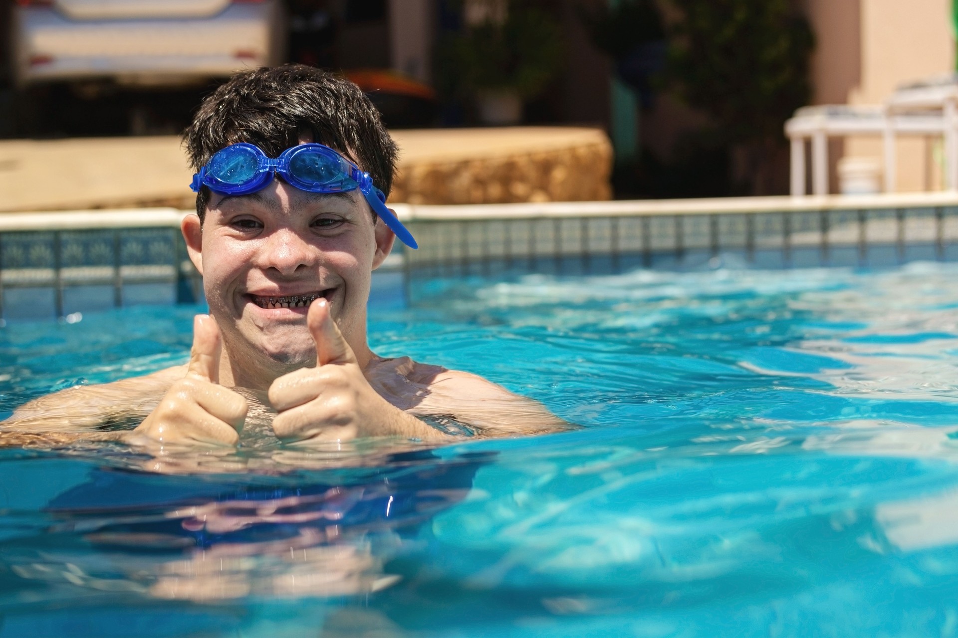 Boy with down syndrome in the swimming pool